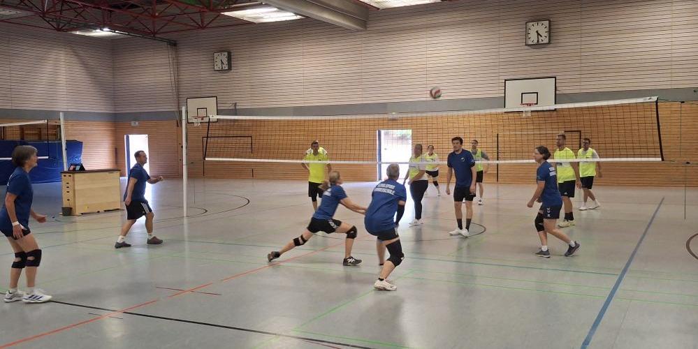 Zwei Mannschaften spielen Volleyball.