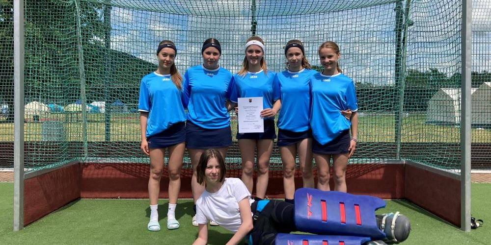 6 Mädchen stehen in einem Hockeytor